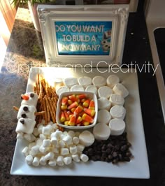 marshmallows, pretzels, and candy are arranged on a platter