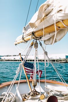 the front end of a sailboat with an american flag on it