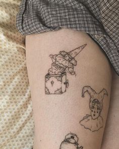 a woman's leg with tattoos on it and some things drawn on the legs