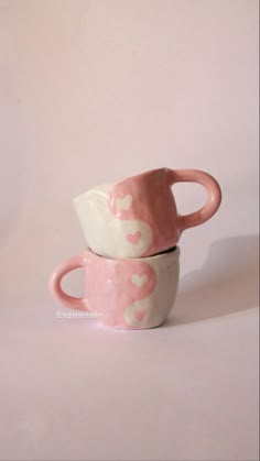 two pink and white cups with hearts on them