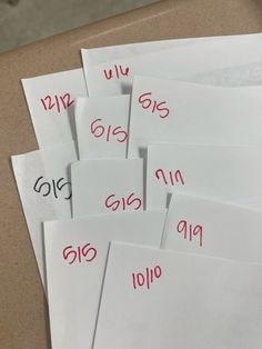 several envelopes with numbers on them sitting on a table