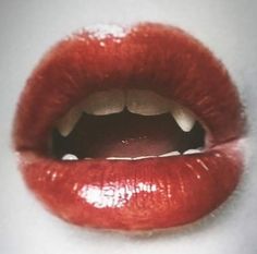 an open mouth with red lipstick on it