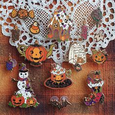 a group of halloween pins sitting on top of a doily