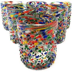 multicolored glass tumblers are lined up together