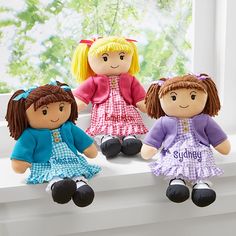 three dolls sitting on a window sill with their name written in the front and back