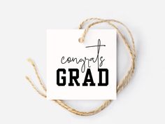 a card with the words congratulations grad on it and some twine around it