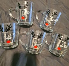 four glass mugs with reindeer antlers on them