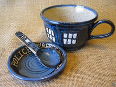 a doctor who mug with a spoon in it on a table next to a bowl