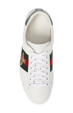 Signature web stripes and bold embroidery bring together two of Gucci's most distinctive house codes on this classic leather sneaker. Contrasting heel tabs are a modern reference to the brand's official colors. Style Name:Gucci New Ace Sneaker (Men). Style Number: 5415061. Gucci Lace-up Sneakers With Logo Detail, Leather Sneakers With Appliqué Logo, White High-top Custom Gucci Sneakers, Sporty Sneakers With Appliqué Logo And White Sole, Sporty Gucci Sneakers With Embroidered Logo, Sporty Leather Sneakers With Appliqué Logo, Gucci Custom Lace-up Sneakers With Embroidered Logo, Gucci High-top Lace-up Sneakers With Logo, White Sneakers With Signature Stripes For Streetwear