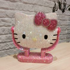 a hello kitty figurine made out of swaroons on a wooden table