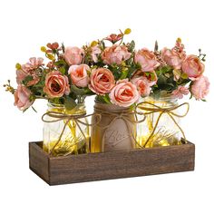 two mason jars filled with pink flowers on a wooden tray