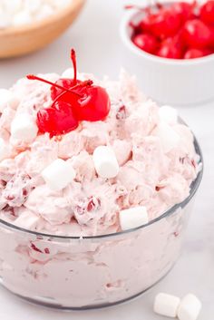 a close up of a bowl of food with marshmallows and cherries