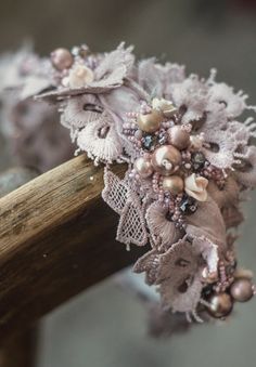 the headband is adorned with pearls and other beads, along with lacework flowers