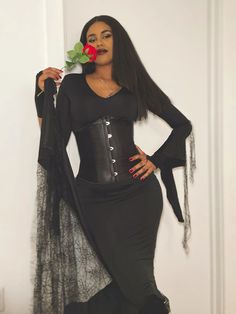 a woman in a black corset holding a rose