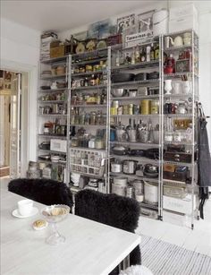 a room filled with lots of shelves covered in pots and pans