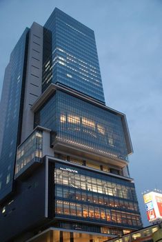 a very tall building with lots of windows on it's side at night time