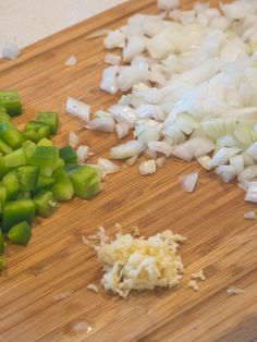 chopped onions and green peppers on a cutting board