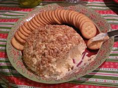 a plate topped with crackers and ice cream on top of a red table cloth