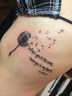 a woman's stomach with a dandelion tattoo on it that says, god is your in his arms i have you in my heart