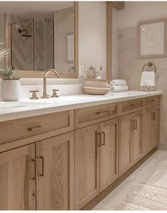 a large bathroom with two sinks and mirrors