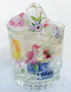 a glass filled with lots of different colored flowers