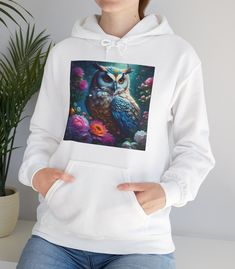 Wrap yourself in warmth and style with this beautifully designed hoodie featuring a vibrant owl surrounded by blooming flowers. This hoodie is both comfortable and durable, making it perfect for any season. The intricate details of the owl's feathers and the rich floral patterns add a touch of nature's beauty to your wardrobe. Owls have long been symbols of wisdom and mystery, appearing in folklore and art throughout history. From ancient Greek mythology where owls represented Athena, to modern Nature Hoodie, Owl Clothes, Owl Fashion, Owl Hoodie, Owl Feather, Hoodie Cozy, Print Hoodie, Hoodie Design, Wildlife Art