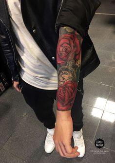 a man with a rose tattoo on his arm