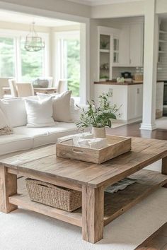 a living room filled with furniture and a wooden table in front of a white couch