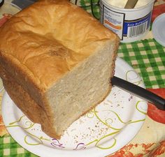 a loaf of bread sitting on top of a plate next to a knife and fork