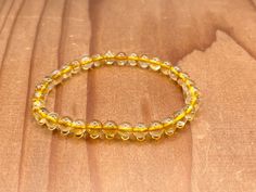 "Get ready to turn heads with this stunning 6mm citrine crystal bead bracelet. Designed to be the perfect size for both men and women, this stretch bracelet measures 7.5 inches but can be sized to suit your needs. Handmade with care, this unisex bracelet features bright and beautiful yellow HTA Citrine gemstones that are sure to grab attention and add a touch of elegance to all your favorite outfits. Citrine has been referred to as the \"success stone,\" \"merchant's stone\" or \"money stone.\" Citrine Bracelet Mens, Crystal Bead Bracelet, Crystal Beads Bracelet, Jewelry For Men, Unisex Bracelets, Citrine Crystal, Citrine Gemstone, Fabulous Jewelry, Beaded Stretch Bracelet