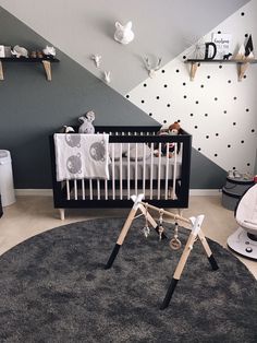 a baby's room with black and white decor