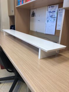 a white shelf sitting on top of a wooden desk