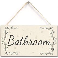 a bathroom sign hanging on a wall with the word'bathroom'written in cursive writing