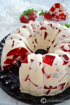 a bundt cake covered in white icing and strawberries