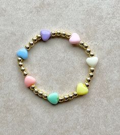 Gold Heart Charm Bracelet For Birthday, Cute Handmade Gold Beaded Bracelets, Playful Gold Beaded Bracelets For Everyday, Cute Gold Beaded Bracelets With Heart Beads, Playful Gold Bracelets With Colorful Beads, Cute Multicolor Heart Bracelet For Gift, Cute Personalized Gold Stretch Bracelet, Cute Multicolor Heart Bracelet Gift, Cute Adjustable Gold Charm Bracelet