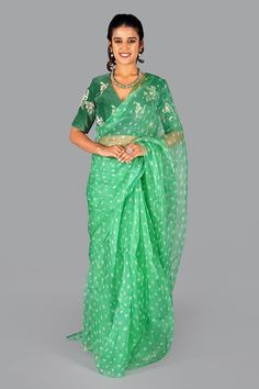 Green organza saree with all over bandhani patterns. Comes with floral thread embroidered blouse. - Aza Fashions Organza Blouse Piece With Pallu In Green, Green Organza Blouse Piece With Pallu, Festival Chikankari Embroidery Organza Choli, Chanderi V-neck Traditional Wear For Festivals, Green Organza Saree Traditional Wear, Festive Chanderi V-neck Traditional Wear, V-neck Chanderi Traditional Wear For Festivals, Fitted Organza Saree For Festivals, V-neck Traditional Wear With Zari Work For Diwali