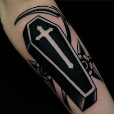 a black and white tattoo with a cross on it's arm that has an arrow in the center