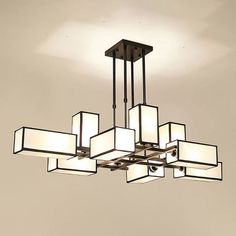 a chandelier with square and rectangular lights hanging from it's center beam