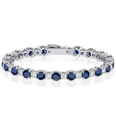 a white gold bracelet with blue sapphires and diamonds on the side, set in 18k