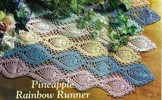 a crocheted table runner with flowers and leaves on the top, along with text that reads pineapple rainbow runner