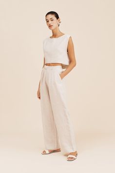 The Martina Crop Top features a high neckline and has a relaxed, slightly cropped silhouette. Wear it as a set with the matching Louis Trouser or pair it with your favourite high-waisted jeans. Cropped fit Relaxed silhouette Wide neckline Self-lined Material: 100% EU certified flax linen Made in India Our natural linen is an undyed linen yarn and represents the fabric's natural colour. Slight colour variations may occur between batches as we produce in small quantities to keep our manufacturing Versatile Cropped Relaxed Fit Pants, Versatile Cropped Pants With Relaxed Fit, Chic Relaxed Fit Cropped Top, Chic Relaxed Fit Crop Top For Loungewear, Trouser Pocket, Jeans Cropped, Linen Yarn, Jumpsuit Jacket, Knit Sweatshirt