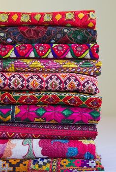 a stack of different colored fabrics sitting on top of each other