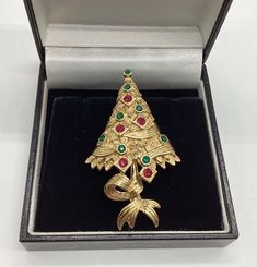 "A fabulous and rare piece of Atwood and Sawyer \"The Christmas Tree\" Beautiful quality and condition. A perfect gift in lovely condition with all stones in place.   Founded in Wales in 1956 by Horace Atwood, Atwood and Sawyer produced copies of precious ornaments from the 18th to 19th centuries. Many pieces were made for the television series \"Dallas\" and \"Dynasty\", as well as exclusive compositions for the beauty contest \"Miss World\". The firm produced high-end jewellery and it was sold at  prestigious retail outlets across the UK, Europe and other countries around the world, as well as on cruise ships and Airliners. A special recognition was given to their historical collection of exact copies of the jewellery of the Duchess of Windsor. Measures 2 inches by just over 1 inch Pin a Gold Brooches For Christmas Gift, Gold Christmas Brooches For Formal Wear, Gold Brooches For Formal Christmas Occasion, Gold Holiday Brooch Jewelry, Formal Christmas Brooch Jewelry, Holiday Formal Brooch Jewelry, Elegant Gold Christmas Brooches, Holiday Formal Jewelry Brooch, Formal Holiday Brooch Jewelry