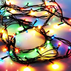 multicolored christmas lights on white background