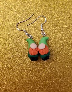 St Patrick's day gnome earrings are so cute! These would make a great gift for a special person. Also great to wear anywhere on this holiday or any day. Make the day festive with these cute gnome earrings. 2 shade of greenon the body. These are about 3 to 5 cm not big just the perfect size. Sterling silver hooks Polymer clay are used for the gnomes all handmade so each one the look the same but are also different. Fun Green Earrings For Gifting, Quirky Green Jewelry As A Gift, Green Fun Earrings For Gift, Cute Green Earrings For Birthday, Fun Green Earrings For Gifts, Quirky Hypoallergenic Jewelry Gift, Quirky Green Jewelry For Gift, Fun Green Earrings For Birthday, Quirky Green Jewelry For Gifts