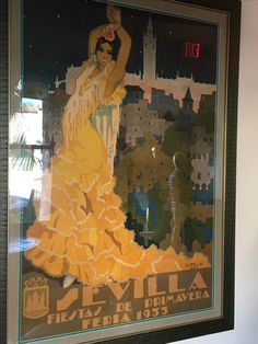 a poster is hanging on the wall in front of a window that shows a woman dancing