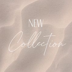 the words new collection written in white ink on a sandy beach sand background with small waves