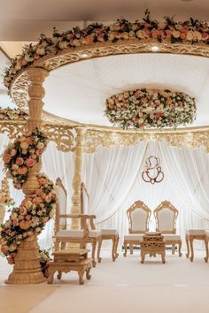 an elaborately decorated room with white drapes and floral decorations