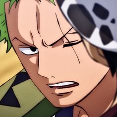 an anime character with green hair and blue eyes looking at something in front of him