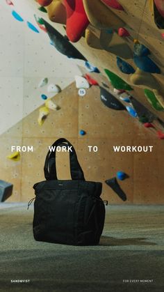 a black bag sitting on the ground in front of a wall full of skateboards